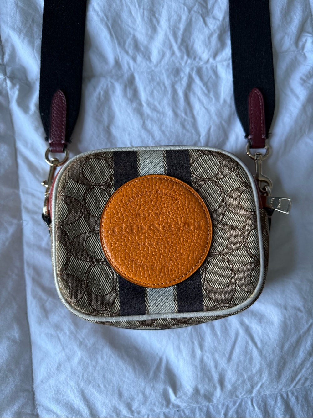 Coach Tan Signature Canvas Crossbody camera bag with Orange Leather Patch